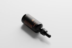 a black bottle with a black cap on a white surface